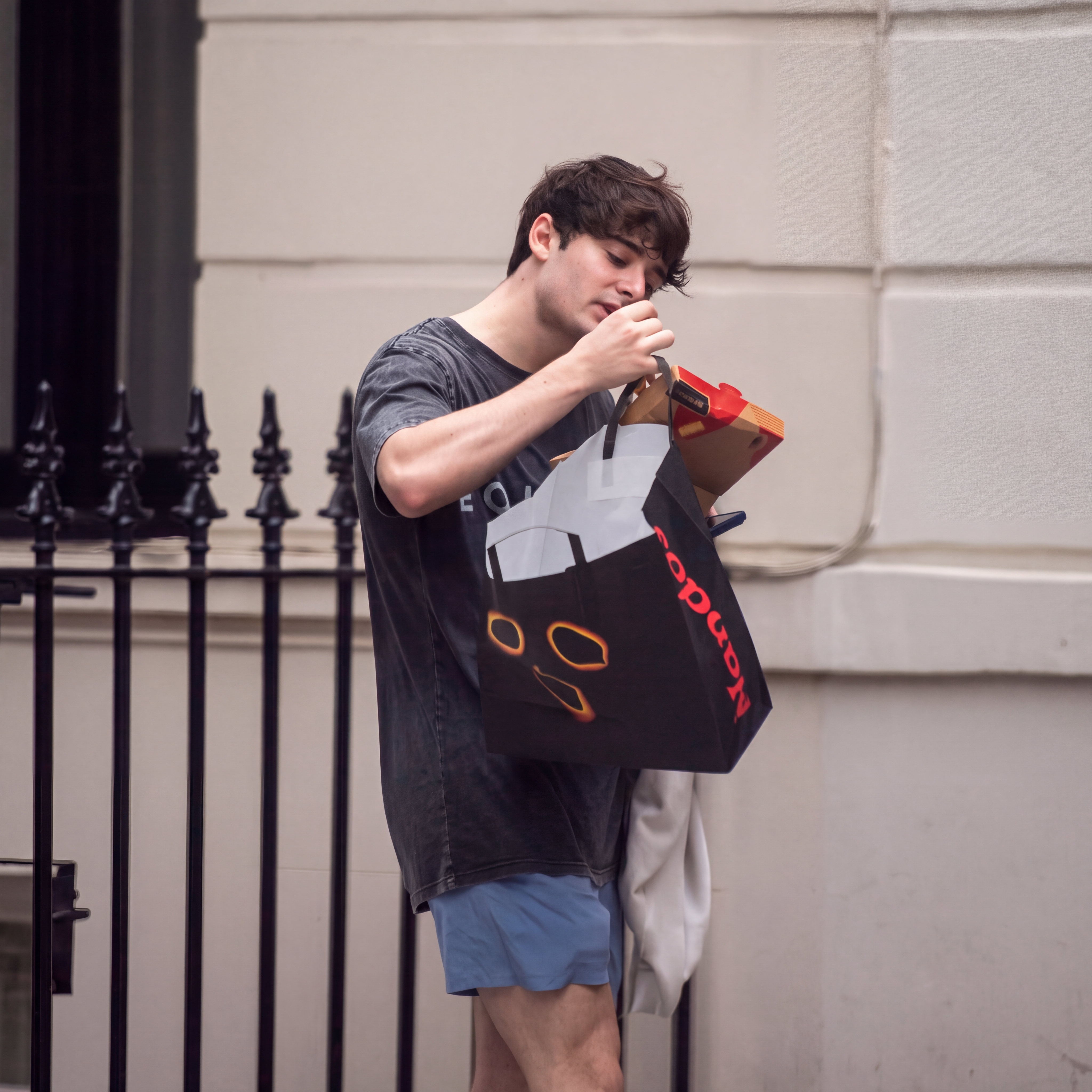 Noah Schnapp and Sheridan Townsley walking together after the gym, Noah holding a Nando's takeaway bag