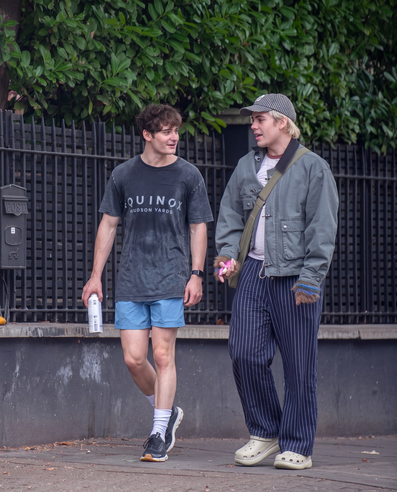 Noah Schnapp and Sheridan Townsley walking outside after a gym session, with Schnapp holding a Nando's takeaway bag