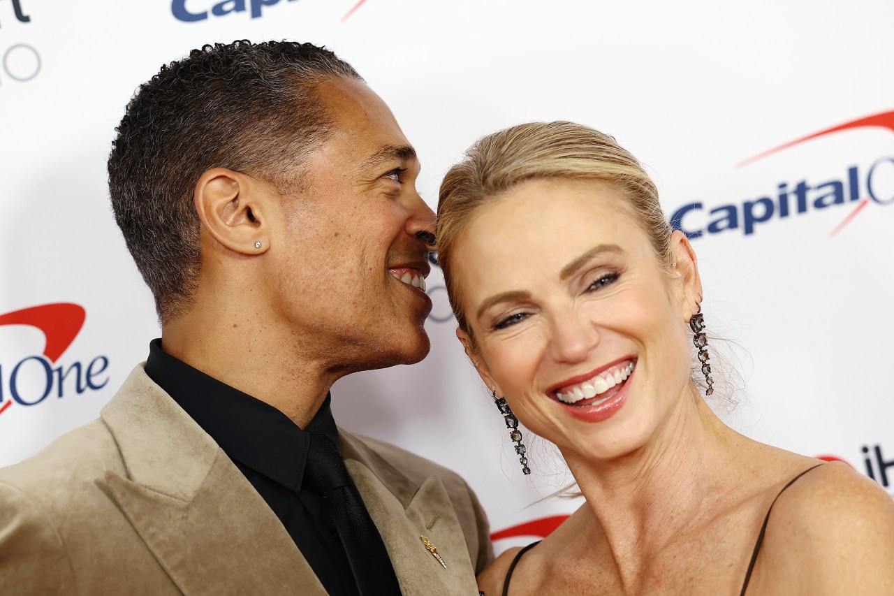 T.J. Holmes and Amy Robach posing together at iHeartRadio Jingle Ball 2025 at Madison Square Garden in New York City
