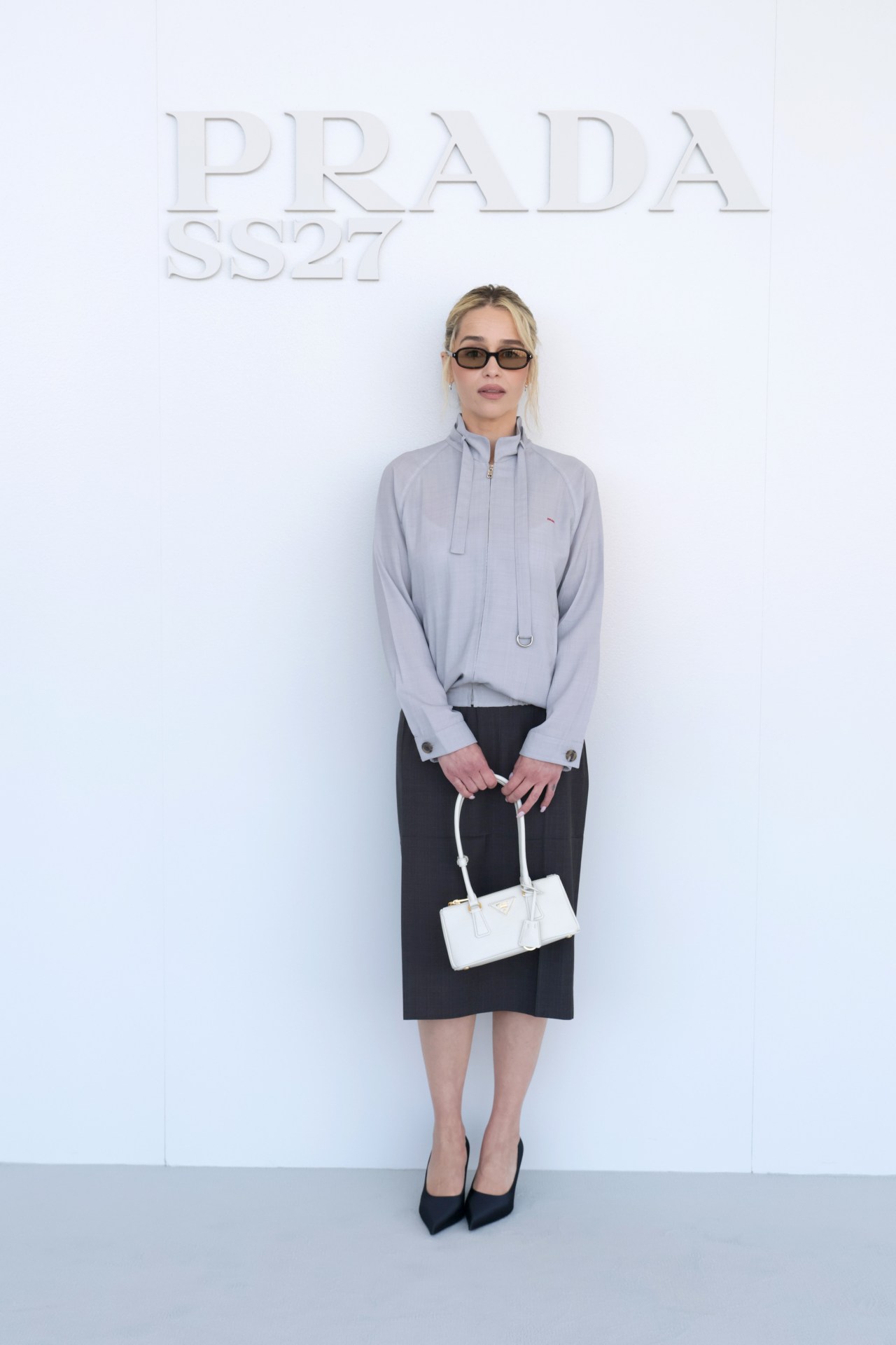 Emilia Clarke seated in the front row at the Prada Spring/Summer 2027 womenswear fashion show in Milan