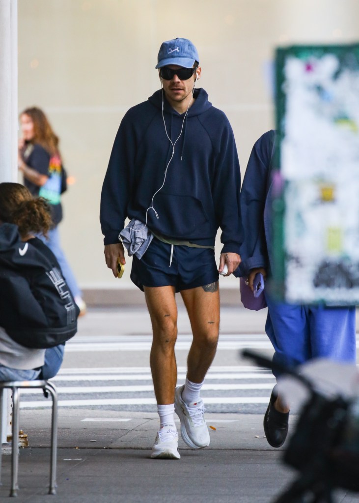 Harry Styles walking on a sidewalk in New York City