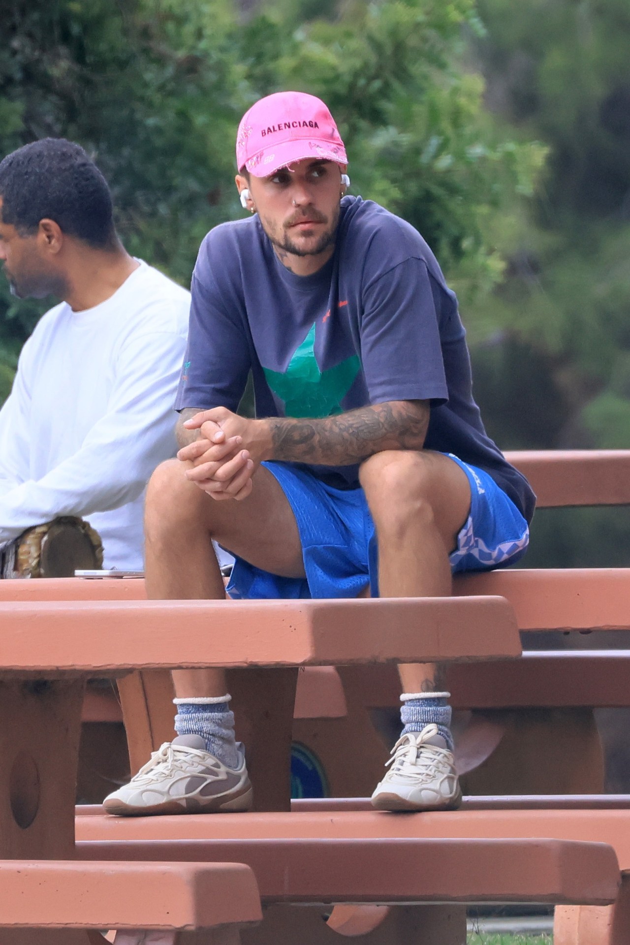 Justin Bieber walking outdoors in Studio City wearing AirPods and carrying a large insulated water bottle