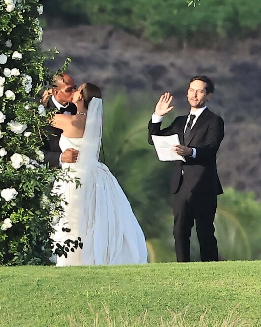 Tobey Maguire in a black suit officiating Jennifer Meyer and Geoff Ogunlesi's wedding ceremony in Hawaii